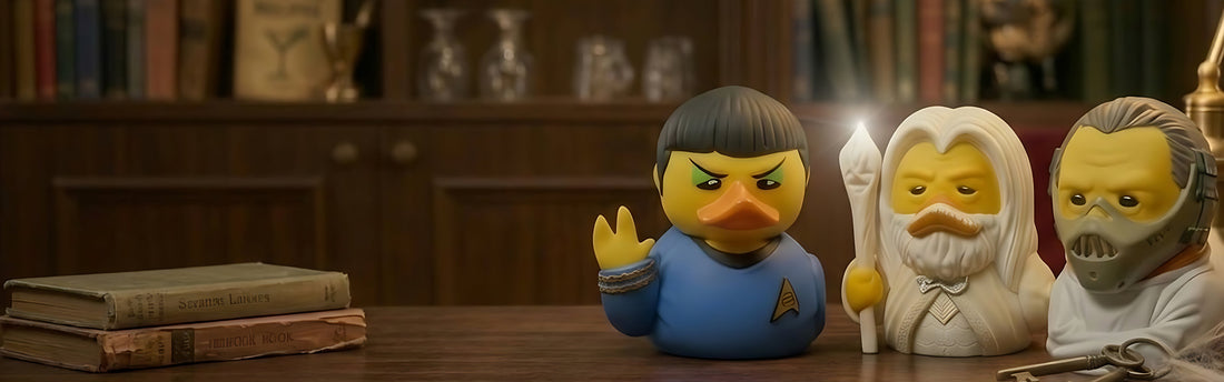 TUBBZ officially licensed collectible duck figures styled as sci-fi and fantasy characters displayed on a wooden desk in a library setting