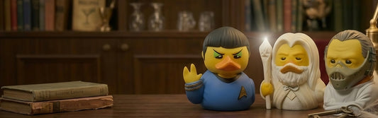 TUBBZ officially licensed collectible duck figures styled as sci-fi and fantasy characters displayed on a wooden desk in a library setting